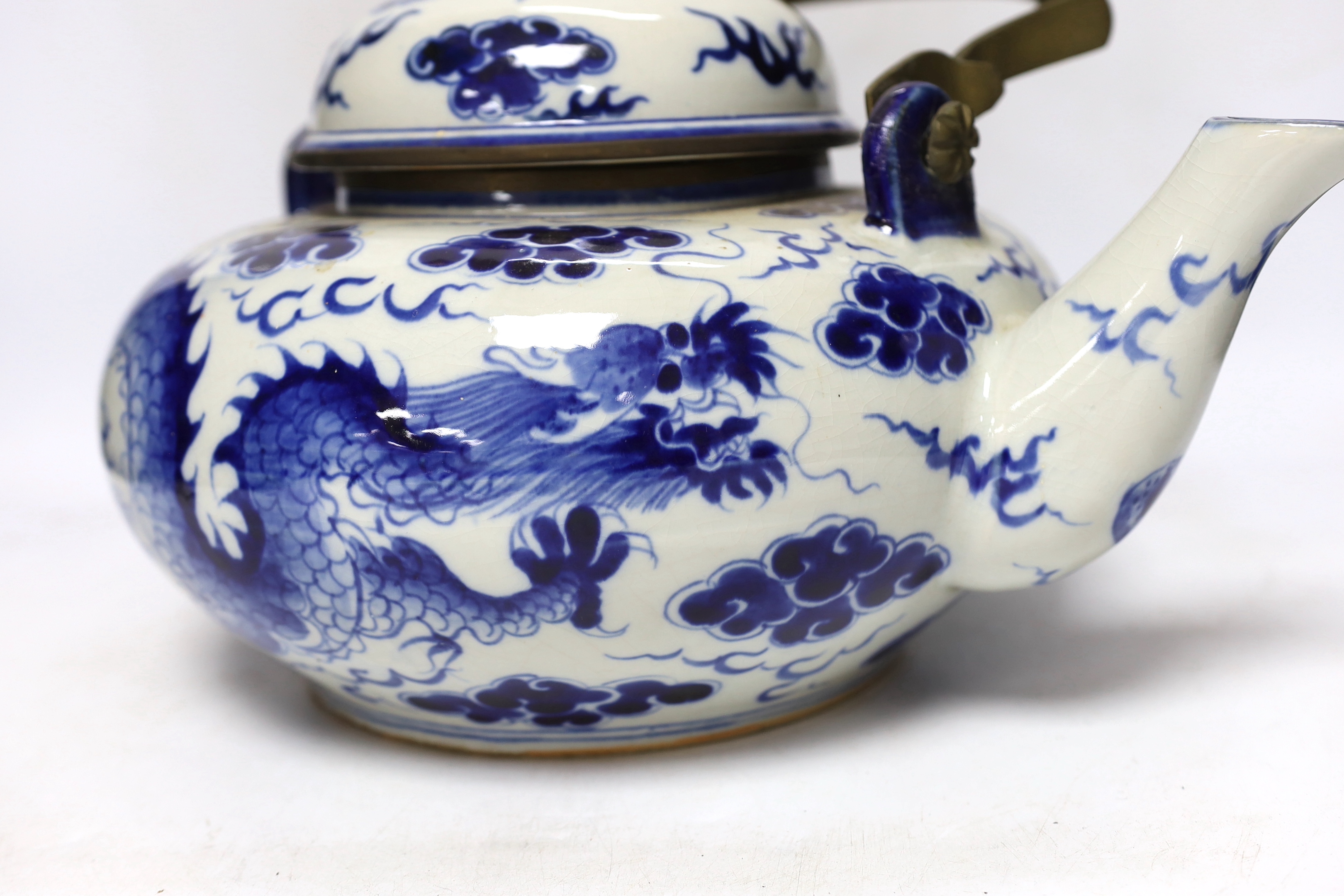 A large Chinese blue and white ‘dragon’ teapot, 38cm wide